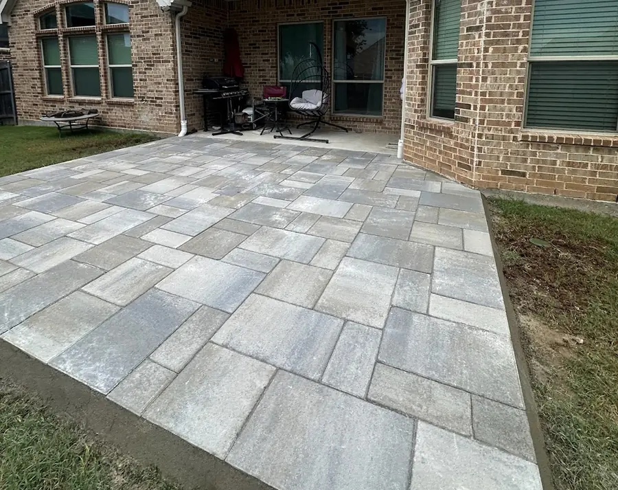 Large paver patio built off the back of a brick home in North Texas
