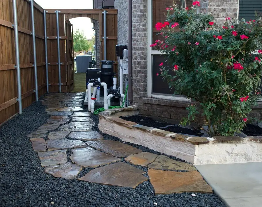 Flagstone walkway and raised stone planter bed