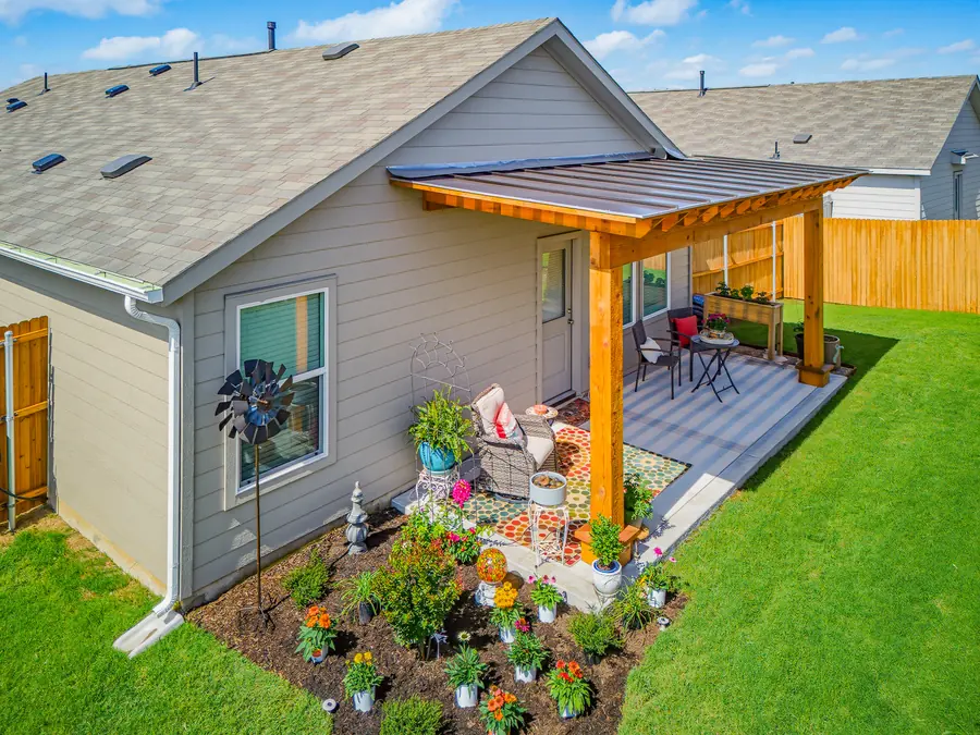 Aerial view of a cedar patio cover with a metal roof over a back patio